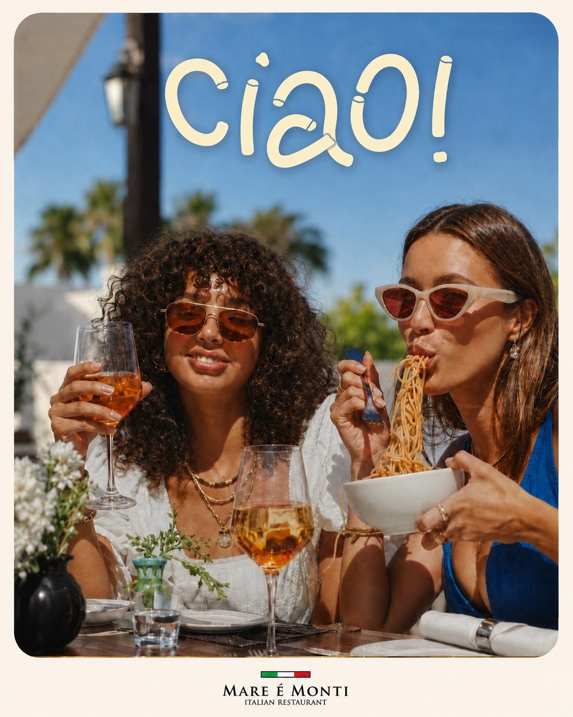 Guests celebrating over pasta and spritz in the sun